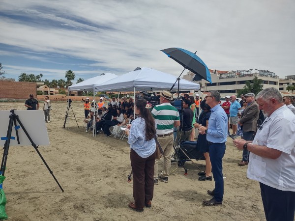 Groundbreaking ceremony on the Palm Springs Surgical Campus site, with tents, seating, and attendees on the cleared lot