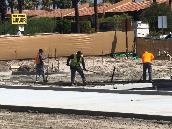Crew placing and finishing site concrete at the Palm Springs Surgical Campus